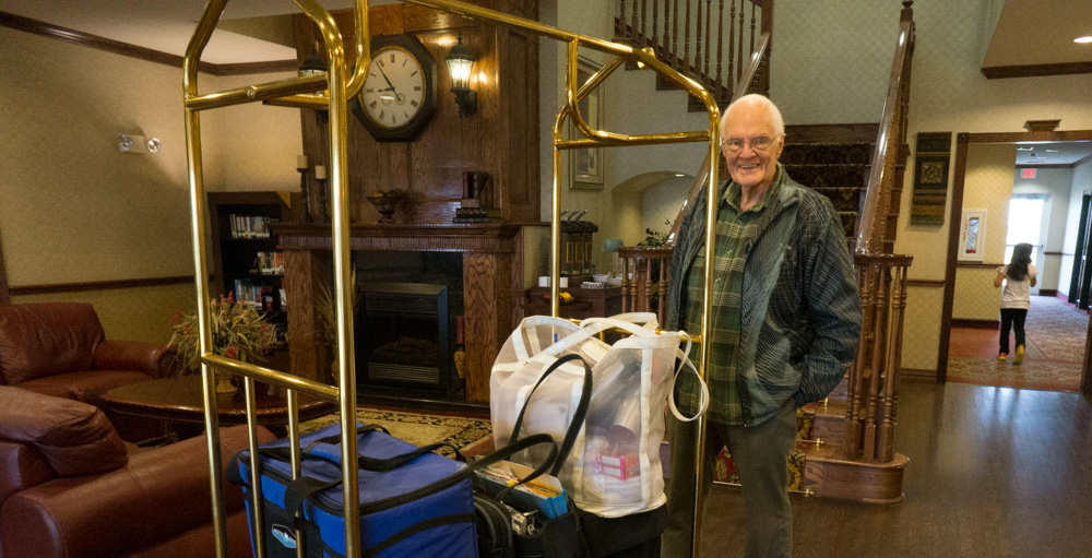 Jim in his green plaid shirt and our luggage, at a hotel